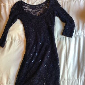 Blue lacy dress with some sequins on it as well